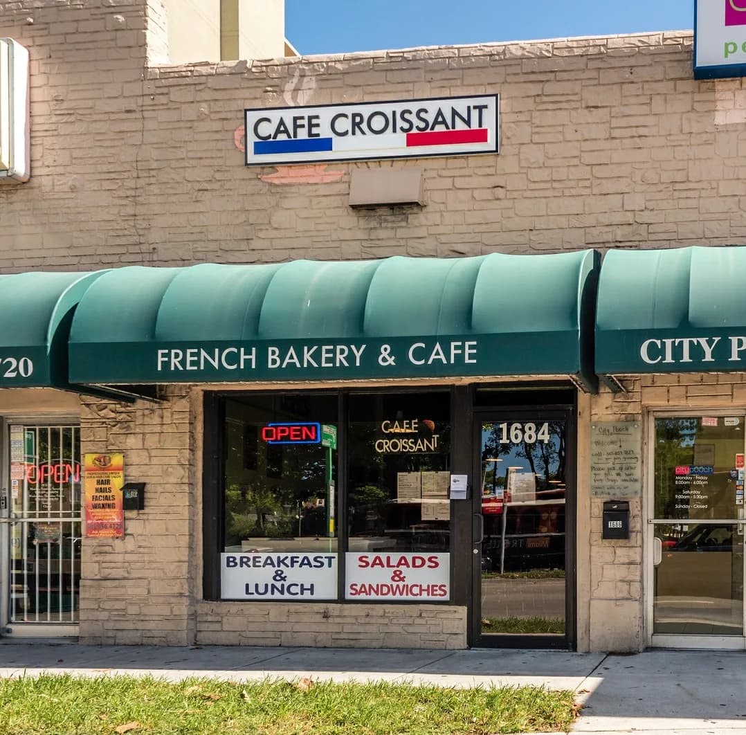 Green awning of Cafe Croissant, French Bakery & Cafe, 1684 Coral Way